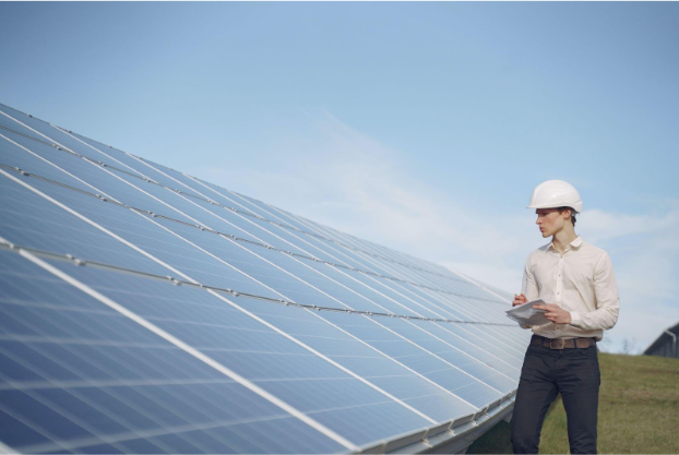 Construction professional assessing a building's solar panels